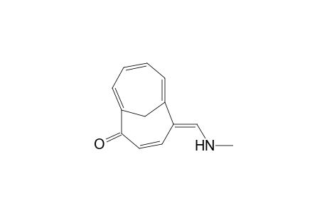 Bicyclo[4.4.1]undeca-3,6,8,10-tetraen-2-one, 5-[(methylamino)methylene]-, (.+-.)-